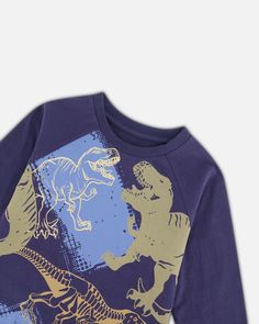 Our Raglan T-Shirt with Dinosaur Print Navy adds style and versatility to any little boy's wardrobe. Made from 100% cotton jersey, this super soft tee features contrast long raglan sleeves, a crew neckline, a curved back hem, and a small logo label on the front. An allover dinosaur print on the front adds a one-of-a-kind touch! Long raglan sleeve tee Crew neckline Graphic print 100% Cotton Fits true to size From 2 years to 12 years