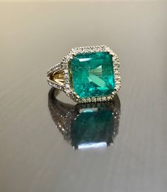 DeKara Designs Collection Metal- 18K Yellow Gold, .583. Stones- 1 Emerald Cut Green Colombian Emerald 7.12 Carats, 10.9 x 11.1 MM. 92 Round Diamonds G Color VS2 Clarity, 1.00 Carats. Art Deco Inspired Beautifully Cut and Colored Colombian Green Emerald Halo Diamond Engagement Ring Made in 18K Yellow Gold. . The pictures do not capture the true beauty, brilliance, and color of this Emerald ring. The Emerald is as square as possible for the best possible proportions. The emerald is surrounded by 3 Luxury Green Emerald Halo Ring, Exquisite Yellow Gold Emerald Diamond Ring, Luxury Gold Emerald Ring With Halo Setting, Exquisite Yellow Gold Emerald Ring, Luxury Yellow Gold Wedding Ring With Accent Stones, Luxury 14k Gold Emerald Wedding Ring, Exquisite Yellow Gold Ring With Emerald, Formal Emerald Rings Fine Jewelry, Luxury Emerald Ring With Prong Setting For Wedding