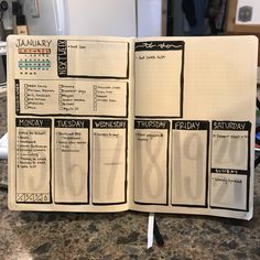 an open planner book sitting on top of a counter