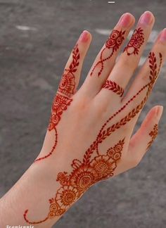 a woman's hand with henna on it