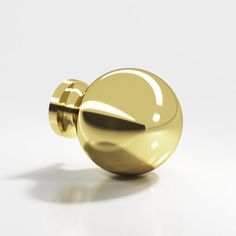 a shiny gold door knob on a white background with shadow from the top to the bottom