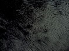 an animal fur texture is shown in black and grey colors, as well as the background