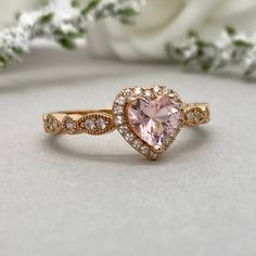 This beautiful ring is made from genuine 925 sterling silver with rose gold plating. Ring details- -The Main stone is a heart shape 6mm High Quality Lab Created Pink Morganite Stone -Side stones are round 1.5mm and 1.1mm simulated diamonds -Ring is casted in solid 925 sterling silver with rose gold plating (yellow gold and rhodium plated also available, please check the drop down menu for more options) -The Total face height of the ring measures 8mms and the band width measures 2mms -Each ring i Pink Heart Rings, Cute Promise Rings, Heart Wedding Rings, Gold Heart Ring, Heart Engagement Rings, Simulated Diamond Rings, Ring Halo, Engagement Ring Shapes, Heart Shaped Rings