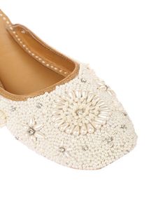 Perle is one of the most prestigious pairs from our collection. Fit for every girl! With an open back, this pair is classy, elegant and graceful. Set on a white base, studded with elegant creamy pearls that makes a beautiful flower in the middle and clustered with silver rhinestones that adds a graceful sparkle to the whole shoe. Gift it to your loved ones on their special days and feel the true essence of love. Color: White Fabric: Leather Upper- leather - leather lining cushion for extra comfo Flat Shoes For Women, White Flat Shoes, Shiny Shoes, Contemporary Glam, Bridal Elegance, White Flat, Bold Jewelry, Bridal Jewellery Indian, White Flats