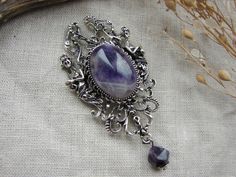 Introducing this exquisite Purple Amethyst Brooch, a captivating blend of Victorian elegance and Romantic allure. This timeless piece features a silver coloured filigree setting that beautifully complements the deep, rich tones of the natural Purple Amethyst stone. The intricate design exudes a romantic charm, reminiscent of a bygone era while adding a touch of mystery and sophistication. Brooch size - 8x4.2 cm or 3.1x1.6 inch You will receive the exact brooch shown in the photo. This brooch isn't just reserved for special occasions - it's a statement of personal style that can be incorporated into your everyday look. Pin it to your favorite jacket, cloak, or scarf to infuse a touch of victorian flair into your attire. 🌙 Please bear in mind that photo may slightly different from actual it Arthur Dayne, Gothic Brooch, Amethyst Brooch, Victorian Elegance, Vintage Silver Jewelry, Style Gothic, Bygone Era, Jewelry Birthday, Silver Filigree