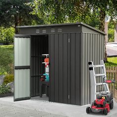 a small metal shed with a lawn mower next to it and a ladder on the side