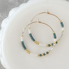 Beautify your winter look with these gorgeous holiday hoop earrings! Crafted with lightweight, hypoallergenic materials and beaded with festive colors, they're sure to turn heads and spread holiday cheer! Stand out from the crowd this season with these limited edition beauties! • Hoops measure 30mm• Earrings are made with Sterling Silver or 14k Gold Filled wire. No plating.• 100% hypoallergenic and tarnish resistant Hoops With Beads, Metal Hoop Beaded Earrings, Handmade Beaded Hoop Earrings Gift, Metal Beaded Hoop Earrings As A Gift, Festive Dangle Hoop Earrings With Beads, Festive Beaded Hoop Earrings, Winter Beaded Earrings, Hoop Earrings Ideas, Hoop Earrings Diy