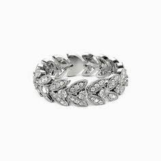 a white gold and diamond ring with leaves on the front, surrounded by smaller diamonds