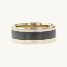 a black and yellow gold wedding ring with two tone stripes on the inside of it