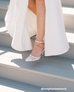 a woman's feet in high heels on the steps with her dress flowing down