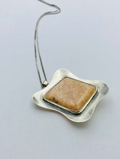 { d e s c r i p t i o n } Modernist silver pendant / brooch with stone , 1956, Made in Finland Design year: 1956 Material: Sterling Silver, stone Marks: PLP makers mark, Crown in heart ( Finland ), 813 ( Silver ), Helsinki city mark, C7 ( Made in 1956 ),  Size: Pendant: About 5.8 cm (About 2.28 inch) The length of the chain: 41 cm ( About 16.14 inches ) Very good vintage condition, ready to wear. There are light signs of use. Please check the pictures. { shipping } I always ship within 3-5 busin Amber Jewelry With Large Stone As Gift, Antique White Gold Jewelry With Large Pendant, Modern Jewelry With Large Pendant For Anniversary, Amber Pendant With Large Stone, Modern Amber Pendant Jewelry, Modernist Gemstone Jewelry For Anniversary, Vintage White Gold Gemstone Necklace, Unique Silver Square Pendant Jewelry, Modern Natural Stone Pendant Jewelry