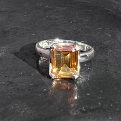 Rectangle faceted citrine ring with filigree design is set in sterling silver, handmade and fair-trade. Shape - Oval Stone Origin - Brazil  Stone Hardness - 7 Metal - 925 sterling silver Weight - 4.1 grams Ring size  -  U.K - O 1/2  U.S. - 7 E.U. - 55 / 15  Stone size -  L 1.1 x B 0.9 x H 0.7 cm L 0.45 x B 0.35 x H 0.3 inch  Band width - 0.3 cm Healing properties - abundance , optimism , self-worth , will power, protection  Shipping - Royalmail recorded Yellow Emerald-cut Topaz Ring, Yellow Citrine Topaz Ring Rectangular Shape, Yellow Rectangular Gemstone Rings, Octagon Shaped Sterling Silver Topaz Ring, Octagon Citrine Gemstone Ring, Yellow Citrine Rectangular Rings, Yellow Rectangular Citrine Ring, Hallmarked Citrine Ring With Emerald Cut, Emerald Cut Citrine Ring Hallmarked