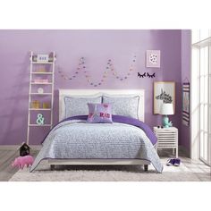 a bedroom with purple walls and white furniture