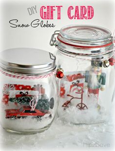 two glass jars with snow globes in them