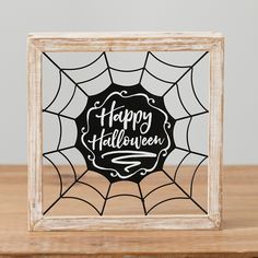 a spider web frame with the words happy halloween in black and white lettering on it