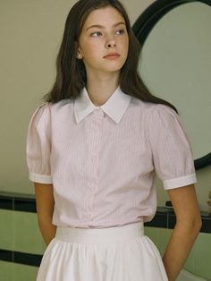 This product is a classic striped shirt with a contemporary twist, featuring puff half sleeves that add a touch of playful sophistication. The crisp collar and button-down front give it a timeless appeal, while the shirt's tailored fit flatters the silhouette. Made from a light and breathable fabric, it's a versatile piece that can be dressed up for the office or styled casually for a weekend outing. - The shirt's puff half sleeves offer a modern update to the conventional sleeve design.- A traditional button-down front ensures a neat and polished look suitable for various occasions.- Its light-striped pattern is both subtle and stylish, lending itself to a variety of pairing options.- The fabric is chosen for comfort and ease, ensuring the shirt is as practical as it is fashionable. Classic Puff Sleeve Shirt With Button Closure, Classic Striped Short Sleeve Shirt For Spring, Short Sleeve Shirt With Striped Collar For Work, Preppy Short Sleeve Workwear Shirt, Preppy Short Sleeve Shirt For Workwear, Preppy Short Sleeve Shirt For Work, Short Sleeve Blouse With Striped Collar For Work, Short Sleeve Top With Striped Collar For Daywear, Daywear Blouse With Striped Collar And Short Sleeves