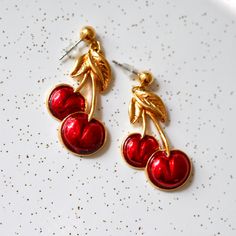 Adorable 1980's Avon cherry earrings with bright red glossy enamel over goldtone.  Era: circa 1980 Hallmark: Avon Measurements: 43mm by 21mm Vintage Red Enamel Earrings, Red Enamel Vintage Earrings, Cherry Drop Earrings, Summer Cherries, Cherry Earrings, Vintage Avon, Bright Red, Favorite Jewelry, Jewelry Earrings Dangle