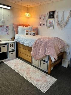 a small bedroom with a bed, desk and storage bins on the carpeted floor