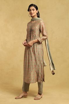 Olive kurta with pintuck detailing on yoke and floral print all over. Paired with inner, pant and dupatta.
Components: 4
Pattern: Printed
Type Of Work: Floral
Neckline: Round
Sleeve Type: Three quarter
Fabric: 80 % Cotton  20% Silk
Color: Green
Other Details: 
Tassel bordered dupatta
Occasion: Puja - Aza Fashions Fitted Cotton Silk Dupatta With Floral Print, Floral Print Cotton Silk Dupatta, Fitted Floral Print Cotton Silk Dupatta, Festive Silk Kurta With Floral Print, Traditional Drape Cotton Silk Sets With Floral Print, Fitted Cotton Silk Sets With Floral Print, Fitted Floral Print Cotton Silk Set, Designer Cotton Silk Kurta With Floral Print, Designer Cotton Silk Floral Print Kurta