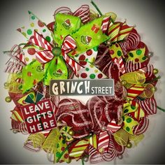 a wreath made out of candy canes and ribbons with the words grinch street on it