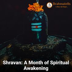 a bottle with flowers in it sitting on top of a wooden table next to the words, shravan a month of spiritual awakeing