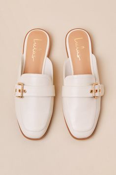 Upgrade your everyday flats with a chic new option like the Lulus Marquete Bone Buckle Mule Slides! These too-cute mules have a smooth, faux leather construction that shapes an almond toe upper and an adjustable strap with a gold buckle and matching grommets. Classic notched collar leads to a slide-on design for effortless styling. 0. 75" rubber heel. Cushioned insole. Rubber sole has nonskid markings. Man made materials. Imported. Lulus | Marquete Bone Buckle Mule Slides | Size 10. Spring Faux Leather Closed Toe Slip-ons, Chic White Mules With Buckle Closure, Spring Flat Faux Leather Slip-ons, White Buckle Closure Mules For Spring, Classic Spring Flats With Buckle Closure, Spring White Mules With Buckle Closure, Elegant Beige Flat Mules, Summer Faux Leather Flats With Flat Heel, Cream Slip-ons With Flat Heel For Spring