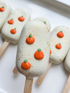 marshmallows with orange and green candies arranged on wooden skewers