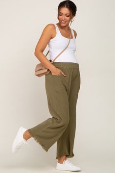 A pair of crop length, linen maternity pants featuring an elastic waistband, side pockets, and fringe trim. The Olive Linen Frayed Hem Crop Maternity Pants is perfectly bump-friendly! Linen Pants Outfit Pregnant, Linen Pregnancy Outfit, Linen Maternity Pants, Linen Pants Maternity Outfit, Linen Pants Pregnancy Outfit, Maternity Wide Leg Pants Outfit, Comfy Pregnancy Outfits Summer, Olive Linen Pants Outfit, Plus Size Pregnancy Outfits