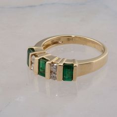 14K Yellow Gold 1 ct Emerald and Diamond Modernist Ring, Fine Quality alternating emeralds and diamonds, 3 emerald cut 3 x 5mm emeralds, 4 round 2.8 mm diamond side stones, sits .25 inch off finger, .82 inch across, Ring size 7, 4.7 grams Stock # BB319R20 This listing contains photographs of the actual item you will receive. Our items are in excellent condition with little or no signs of wear and many are one of a kind pre-owned estate finds. Please look closely at the pictures in this listing a Modernist Ring, Emerald Gem, Claddagh Rings, Jewelry Fashion Trends, Eternity Wedding Band, Fine Jewelry Designers, Boston Ma, Size 10 Rings, Multi Stone Ring