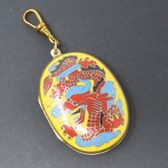 "Vintage 900 Silver Chinese Export Enameled Dragon Flowers Locket Pendant. This wonderful little trinket box locket is new old stock, pristine and unused. It is beautifully enameled on 900 silver with a dragon on the top and flowers wreathed around the sides. The dragon has been stamped in a raised design which can be seen when you open the box - this gives the dragon some pop! The color is deeper and more rich in real life. The locket/box is just a tiny bit under 1 1/4 inches in diameter, and i Antique Enamel Locket Jewelry, Ceremonial Enamel Pendant Jewelry, Antique Multicolor Jewelry Gift, Antique Multicolor Jewelry For Gift, Traditional Enamel Jewelry Collectible, Vintage Enamel Jewelry For Collectors, Vintage Enamel Collectible Jewelry, Vintage Multicolor Enamel Jewelry, Vintage Enamel Jewelry With Rectangular Shape