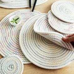 several woven placemats on a wooden table