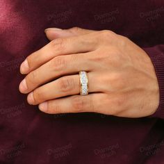 a person wearing a diamond ring on their hand