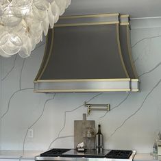 a stove top oven sitting under a light fixture