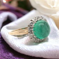 This stunning antique piece was crafted sometime during the Edwardian design period (1900-1920). The 14K gold setting features a center cabochon cut emerald measuring approximately 3 carats. Cabochon cut gemstones are unfaceted, their hue generously saturated. The center emerald is haloed by 14 antique diamond accents. The center emerald features gorgeous hue and saturation. Historically emerald is symbolic of prosperity and truth. This ring is currently is size 6 & 1/2. Sizing available upon re Edwardian Design, Smaragd Ring, Antique Diamond, Fantasy Jewelry, 3 Carat, Emerald Ring, Wedding Rings Engagement, Wedding Engagement, Halo