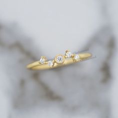 a gold ring with three diamonds on it