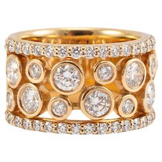 a gold ring with diamonds on the sides and two rows of round stones in each band