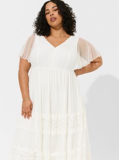 FIT Model is 5'10” wearing size 2. . MATERIALS + CARE Lace woven fabric. 90% nylon, 10% spandex. Machine wash cold. Dry flat. . Imported. DETAILS V-neck. Lace detail. Lined. Flutter sleeves. WHY WE LOVE IT Calling all you desert princesses, bohemian beach beauties, and mountain top queens! Nothing is more chic than a beautiful lace and Swiss-dot gown, and if boho is your style then we can guarantee this wedding dress from our Ever After collection will be the dress of your dreams. The best plus size women's ivory lace a-line boho wedding dress skater dresses in cloud dancer made of lace. Rock your look from Torrid to Festivals like Coachella and Lollapalooza, a concert, a show, or just for fun! This sexy dress will show off your confidence for going out to a cocktail party, date night, gir Stretch A-line Dress For Wedding, White Stretch Dress With Sweetheart Neckline, White Fitted Empire Waist Dress, Cream Flowy Empire Waist Dress, Stretch A-line Wedding Dress, Wedding Dress With Sweetheart Neckline And Stretch, Stretch Wedding Dress With Sweetheart Neckline, Black Beachwear, Embroidered Mesh Dress