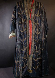 A rare antique Indigo dress, created by beating the cloth, giving it an iridescent glow of a deep purple. Having brass sequins and silk embroidery as well as a coral bead and cowrie shells. Yemen, late 19th or circa 1900-10. A rare museum piece that has been in my collection for 25 years. Fits a size S- M -( SM L ) Bohemian Ceremonial Dresses With Zari Work, Bohemian Dresses With Zari Work For Ceremonial Occasions, Transitional Raw Silk Dress With Mirror Work, Transitional Silk Dress With Mirror Work, Festival Silk Dress With Mirror Work, Traditional Silk Sequin Kaftan, Traditional Silk Kaftan With Sequins, Bohemian Ceremonial Kaftan With Zari Work, Multicolor Bohemian Costume Dress