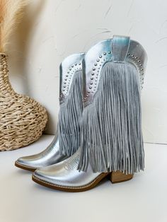 Step out in style with our Adela Studded Fringe Boots in Silver! These boots are perfect for any western-inspired look, with their beautiful fringe details and sleek silver color. Stand out from the crowd and make a statement with these trendy and unique boots. Add them to your wardrobe and elevate your fashion game today! Unique Boots, Fringe Boots, Stand Out From The Crowd, Fashion Games, Silver Color, In Style, Shoe Boots, Sleek, Wardrobe