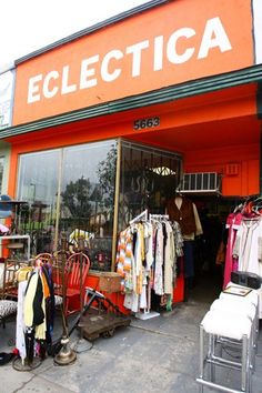 an orange store front with clothes on display