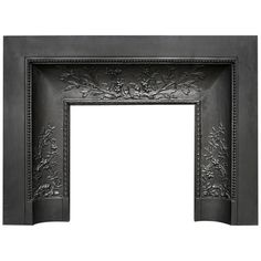 an ornate black fireplace surround with flowers and leaves on the mantle, isolated against a white background