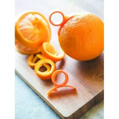 an orange cut in half on top of a cutting board