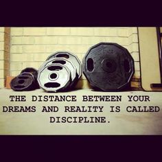 three helmets sitting next to each other on top of a wooden sign that says the distance between your dreams and reality is called discipline