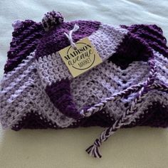 Soft Acrylic Yarn With Deep Plum And Lilac Colors. Suitable For Boys Or Girls. Matching Earflap Hat With Pom Pom Blanket Measures 28" X 36" And Hat Will Fit Newborn To 6 - 9 Months Baby Layette Set, Pom Pom Blanket, Deep Plum, Baby Layette, Layette Set, Lilac Color, Pom Pom Hat, Plum, Kids Accessories