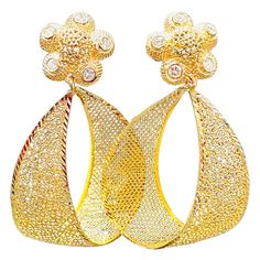 Introducing our exquisite Vintage 21 Karat Yellow Gold Dangling Earrings, a true statement piece adorned with diamonds. These stunning earrings feature a beautiful cut-out net design, adding an elegant touch to their overall aesthetic. Crafted with 21 Karat yellow gold, these earrings weigh 12.8 grams, showcasing the purity and luxuriousness of the gold. The gold is stamped with a 21K mark, ensuring its authenticity and origin from Thailand. Measuring 2.2 inches in length, these earrings offer a Gold Dangling Earrings, Net Design, How To Gain Confidence, Dangling Earrings, Stunning Earrings, Round Brilliant Cut Diamond, True Colors, Jewellery And Watches, Statement Pieces