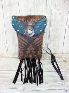 Crafted with a blend of rugged charm and western allure, these one-of-a-kind Leather Crossbody Hipster Purses are the epitome of cowgirl chic. Handcrafted from authentic cowboy boots, each purse exudes a sense of unique style that is perfect for those who embrace country fashion. The fringe detailing adds a touch of flair reminiscent of rodeo culture, making it a must-have accessory for any modern cowgirl. Whether you're hitting the town or attending a western-themed event, these purses effortlessly blend into your wardrobe, elevating your outfit with a dash of western chic. Embrace your inner cowgirl and make a bold statement with these stylish and versatile Crossbody Purses that are bound to turn heads wherever you go.  Cowboy Boot Crossbody Fringe Hipster Bag Handcrafted from Recycled C Western Style Brown Bag With Concho, Bohemian Brown Bags With Concho, Western Bags With Concho Detail, Western Style Bags With Concho, Hand Tooled Brown Bags For Rodeo, Hand Tooled Brown Bag For Rodeo, Brown Rectangular Bag For Rodeo, Brown Hand Tooled Bag For Rodeo, Rectangular Brown Bag For Rodeo