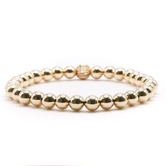 Introducing our 6mm Gold Ball, a must-have accessory for anyone looking to elevate their style. This stunning piece is perfect for gifting or treating yourself, with its warm and luxurious glow from the gold balls. It can be worn on its own or added to a stack of bracelets for a standout look. Whether it's a special occasion or just because, it's sure to impress and become a beloved staple in any collection. Everyday Yellow Gold Bracelet With 8mm Beads, Gold Bracelet With 8mm Beads For Everyday, Everyday Gold Bracelet With 8mm Beads, Classic Gold Stretch Bracelet With 8mm Beads, Gold Beaded Bracelets With Round Beads For Meditation, Minimalist Gold Stretch Bracelet With 8mm Beads, Classic Bracelets With 8mm Beads For Everyday, Yellow Gold Bracelets With 8mm Beads For Everyday, Luxury Gold Beaded Bracelets With Round Beads