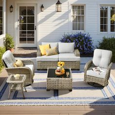 an outdoor living room with wicker furniture