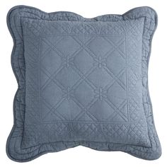 a blue quilted pillow on a white background