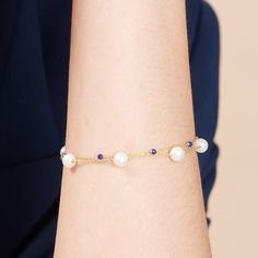 A delicate cultured freshwater pearl fine chain bracelet with a modern twist.    This elegant bracelet combines almost round cultured freshwater pearls with lapis lazuli gemstones to create a stunning piece to be worn day or night.  The perfect gift for a September birthday baby as lapis lazuli is their birthstone.  Non-tarnish gold style chain bracelet with almost round cultured freshwater pearls & lapis lazuli gemstones on a gold plated sterling silver lobster clasp - approx. 7. 5" with chain.  Please note pearls are organic and may vary in size and may differ in number from the image. Pearls are quite soft and need special care after you wear them. Always store them in a separate jewellery pouch away from other jewellery and it is best to keep them in something soft.  From time to time, Elegant Adjustable Blue Pearl Bracelet, Elegant Blue Adjustable Pearl Bracelet, Elegant Beaded Pearl Bracelet, Beaded Chain Pearl Bracelet Gift, Elegant Beaded Chain Bracelet As Gift, Elegant Beaded Chain Bracelet For Gift, Elegant Adjustable Beaded Pearl Bracelet, Elegant Blue Round Pearl Bracelet, Elegant Blue Pearl Bracelet